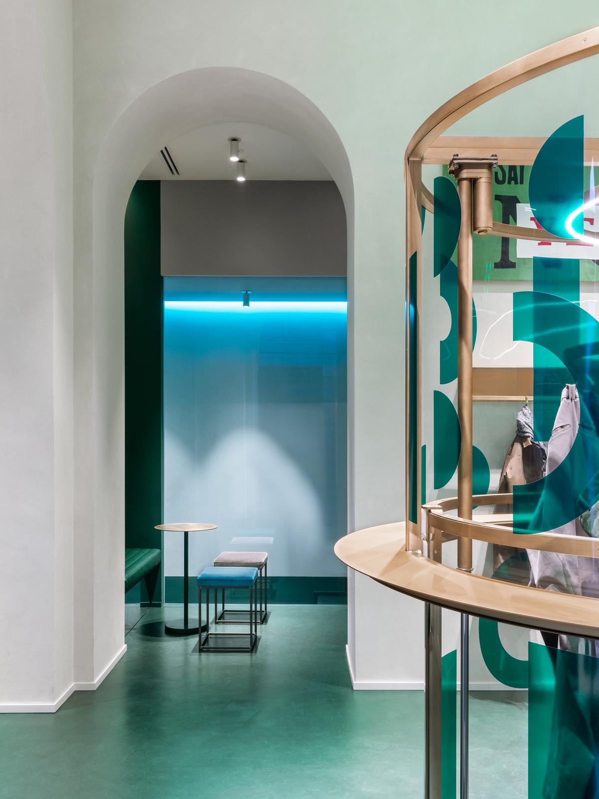 Once descended, the machine provides a counter on which for guests to rest their drinks and a display case for the clothing now contained within / Alessandro Saletta for DSL Studio